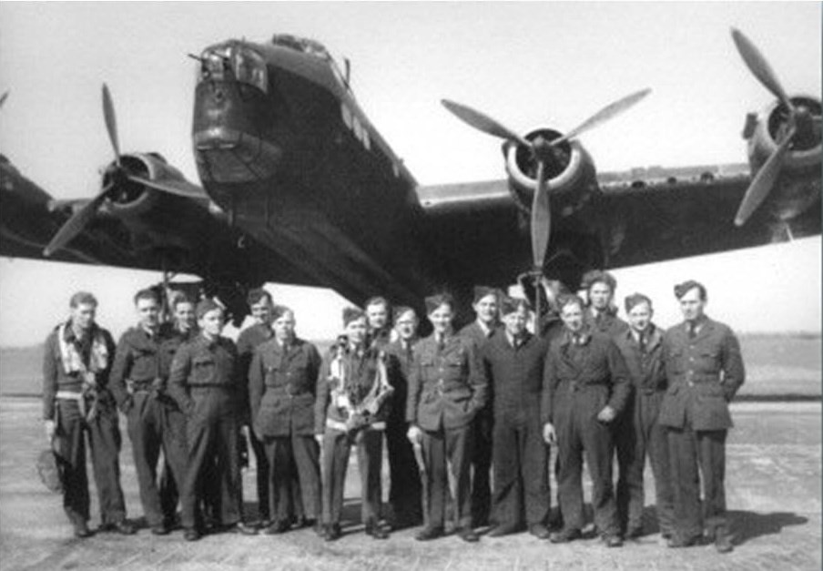 Black and white photo of crew standing by their Halifax aircraft.